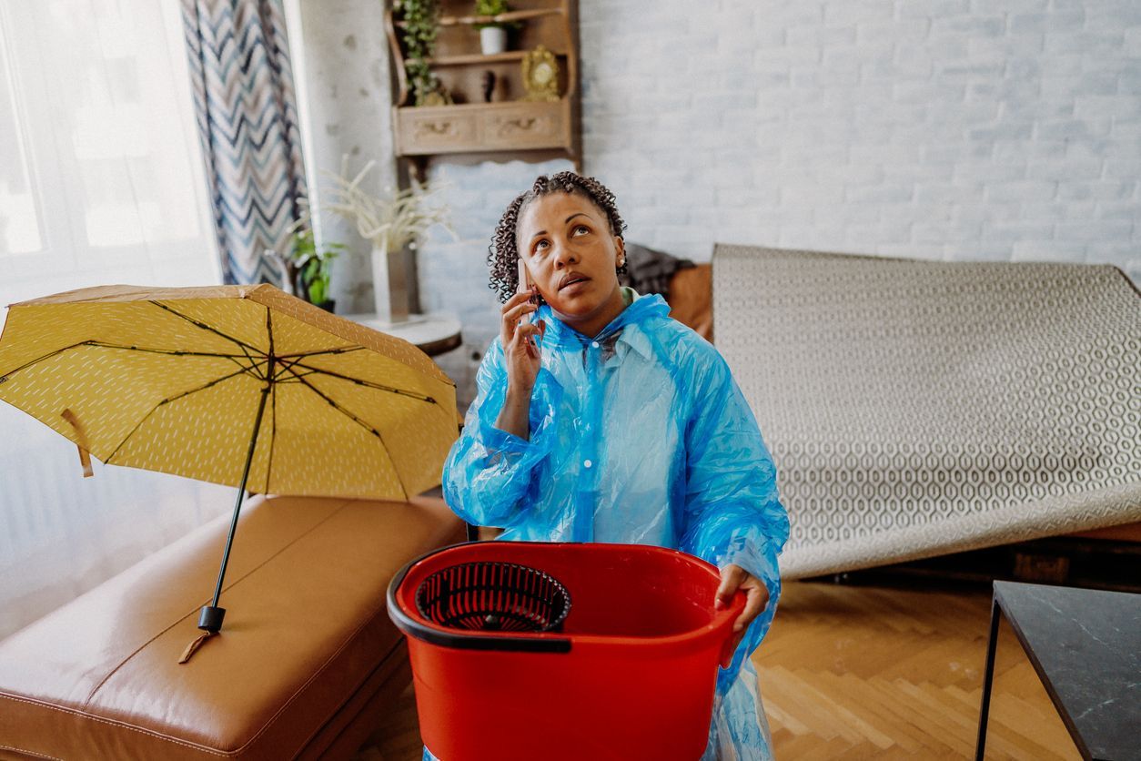 woman reporting water damage at her apartment to her landlord