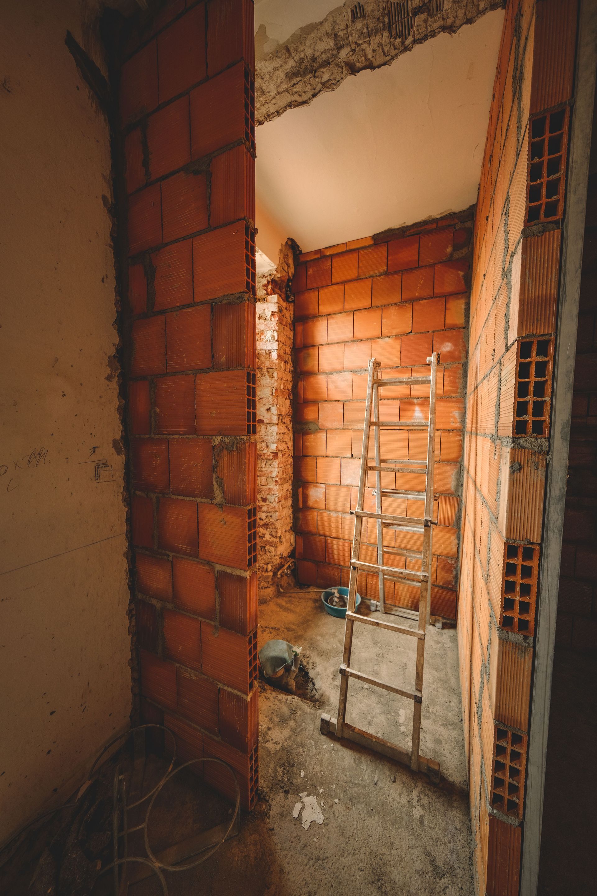 Boarded doorway with bracing to help prevent unauthorized entry and protect a damaged building.
