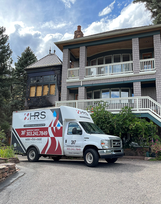 HRS Restoration Services van on-site at a Denver home for emergency water or fire damage restoration. We restore your normal™ with fast, certified service.