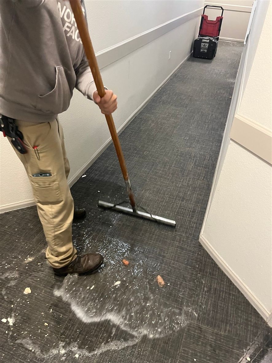 Water damage extraction in a commercial hallway using professional removal equipment in Colorado Springs, CO