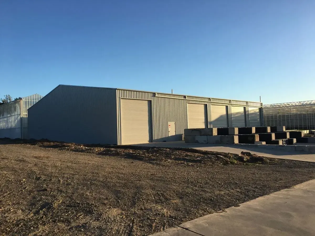 A Large Empty Warehouse with A Concrete Floor — ShedPro Constructions in Darawank, NSW