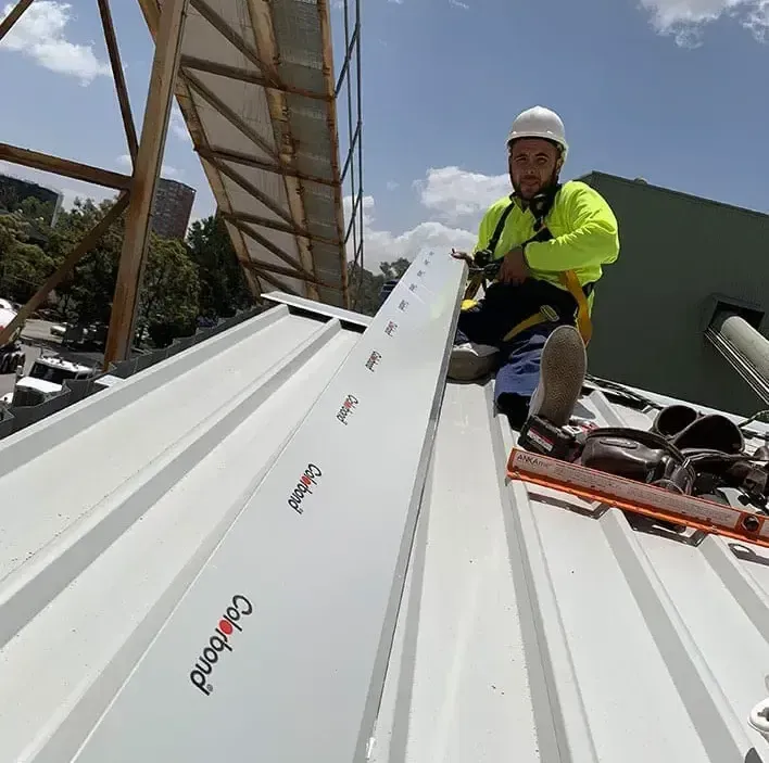 A Large Empty Warehouse with Brick Walls and White Walls — ShedPro Constructions in Darawank, NSW