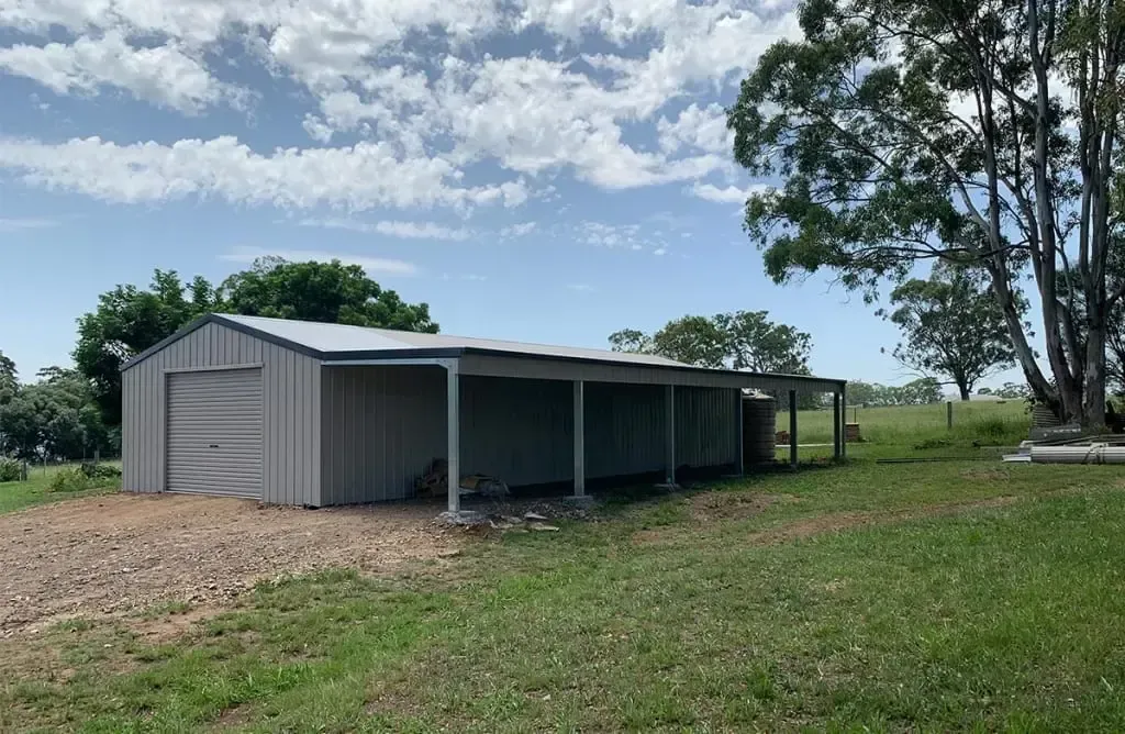 A Barn with A Star on The Side of It — ShedPro Constructions in Darawank, NSW