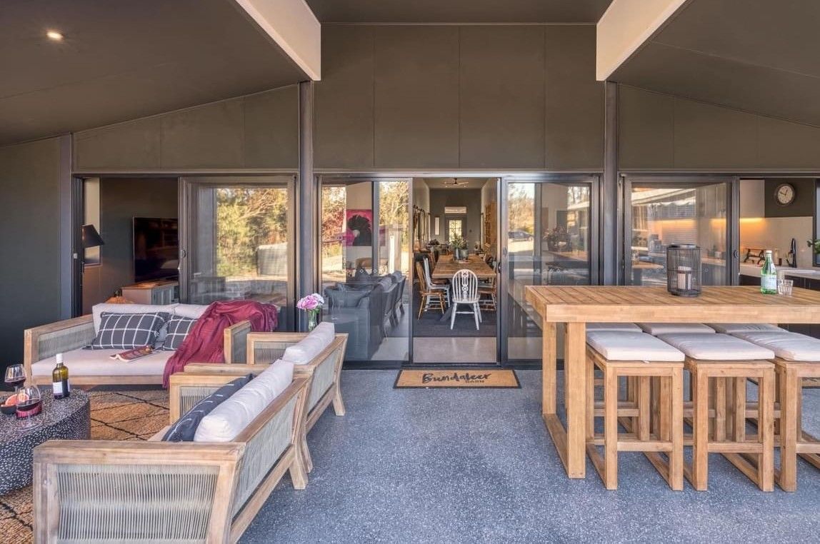 A Patio With a Table and Chairs and a Couch — ShedPro Constructions in Wingham, NSW