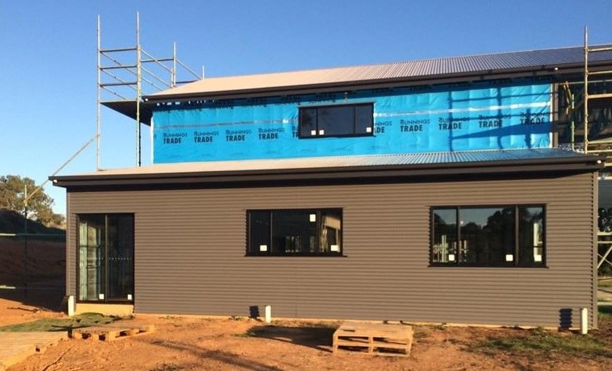 A House is Being Built With a Lot of Windows and Scaffolding — ShedPro Constructions in Bulahdelah, NSW