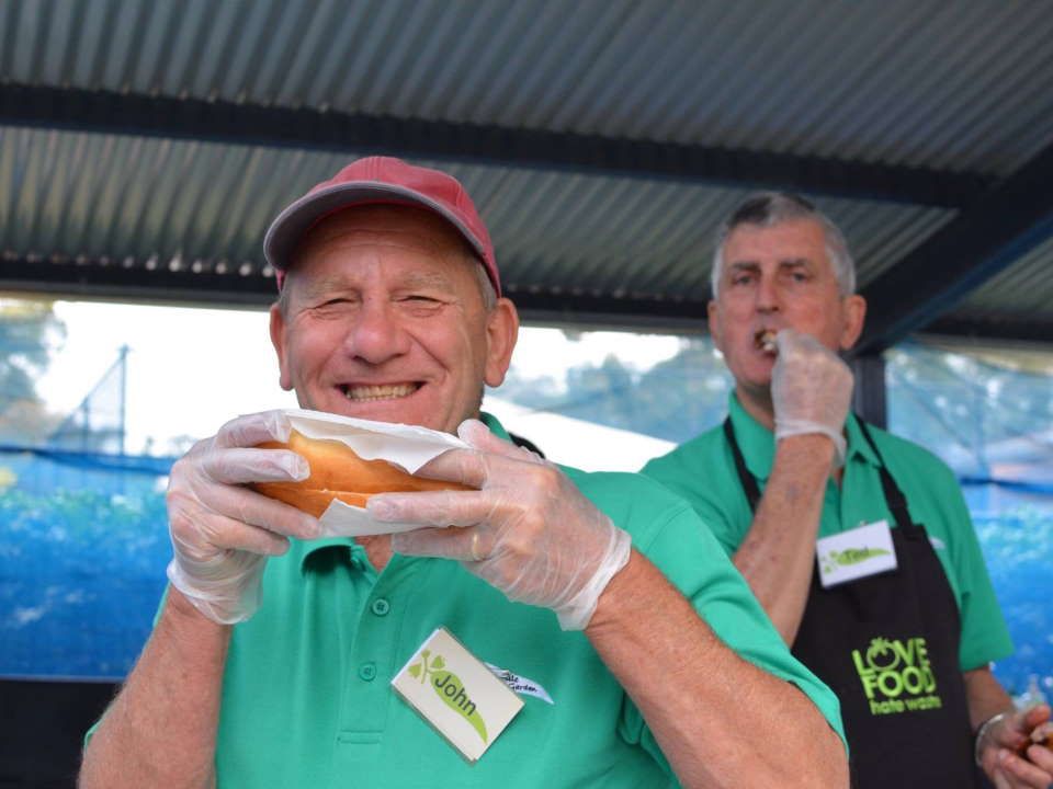 A Couple of Men Eating Food — ShedPro Constructions in Darawank, NSW