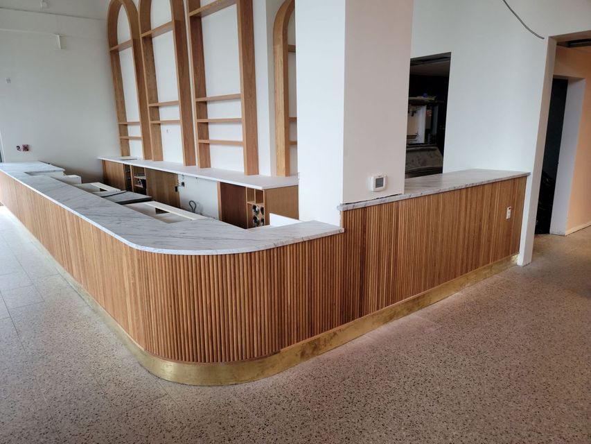 a long wooden counter with a marble counter top