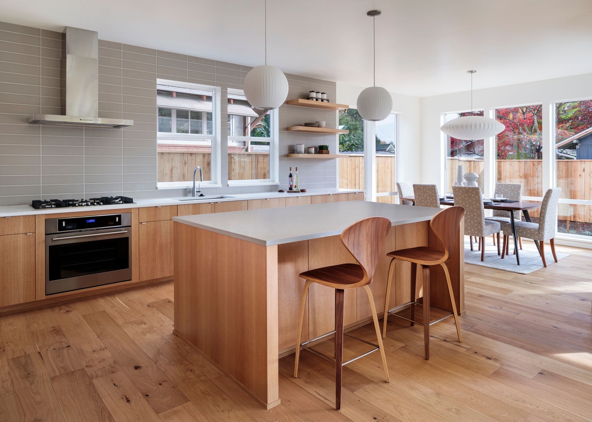 a kitchen with wooden cabinets and a stainless steel oven