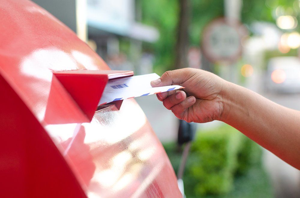 Someone dropping a letter in a mailbox for a direct mail campaign in Aurora, IL Someone dropping a letter in a mailbox for a direct mail campaign in Aurora, IL