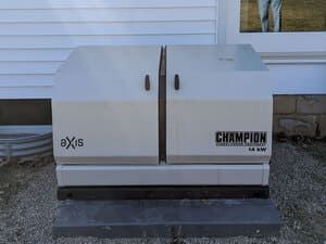 White Champion Axis appliance on a black base against a house wall outdoors