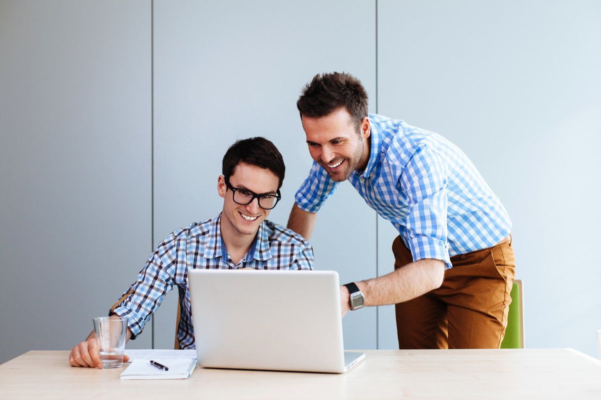 Two web designers looking at a website they designed