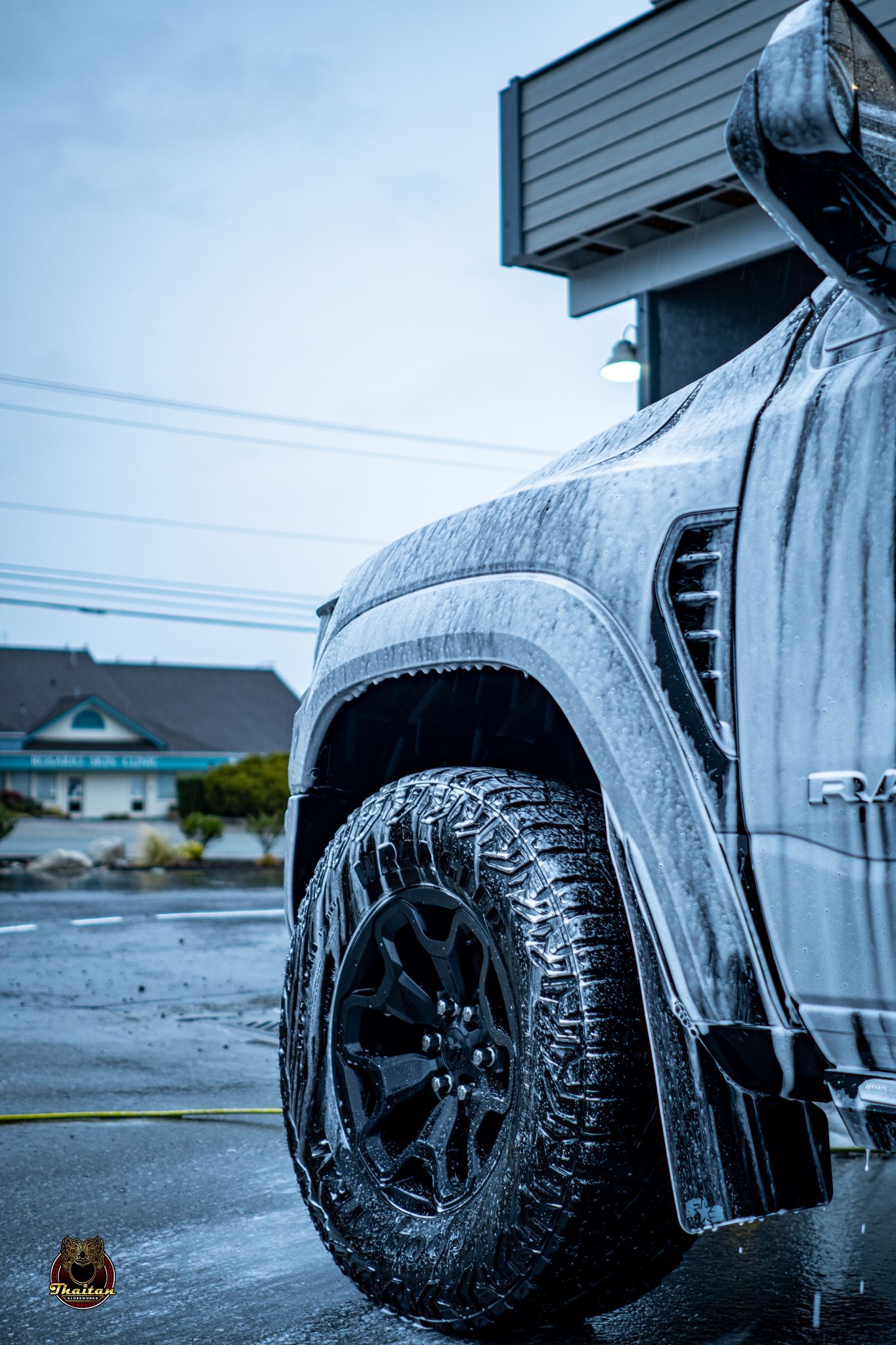 A truck is covered in foam in a parking lot.
