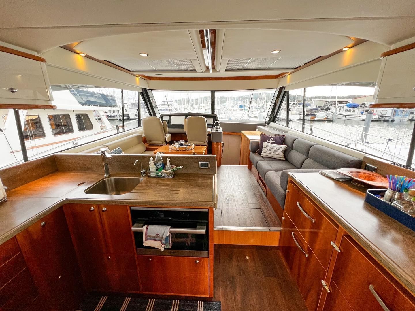 The inside of a boat with a couch and a sink.