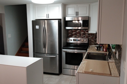 A kitchen with stainless steel appliances and white cabinets A kitchen with stainless steel appliances and white cabinets