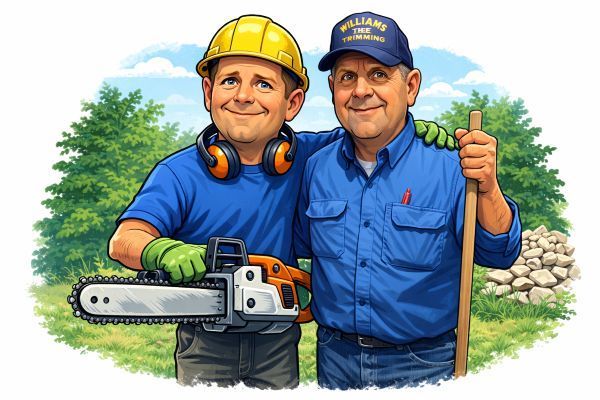Justin Williams and Bruce Williams Two smiling individuals in work attire pose outdoors; one holds a chainsaw, the other holds a shovel near a rock pile.