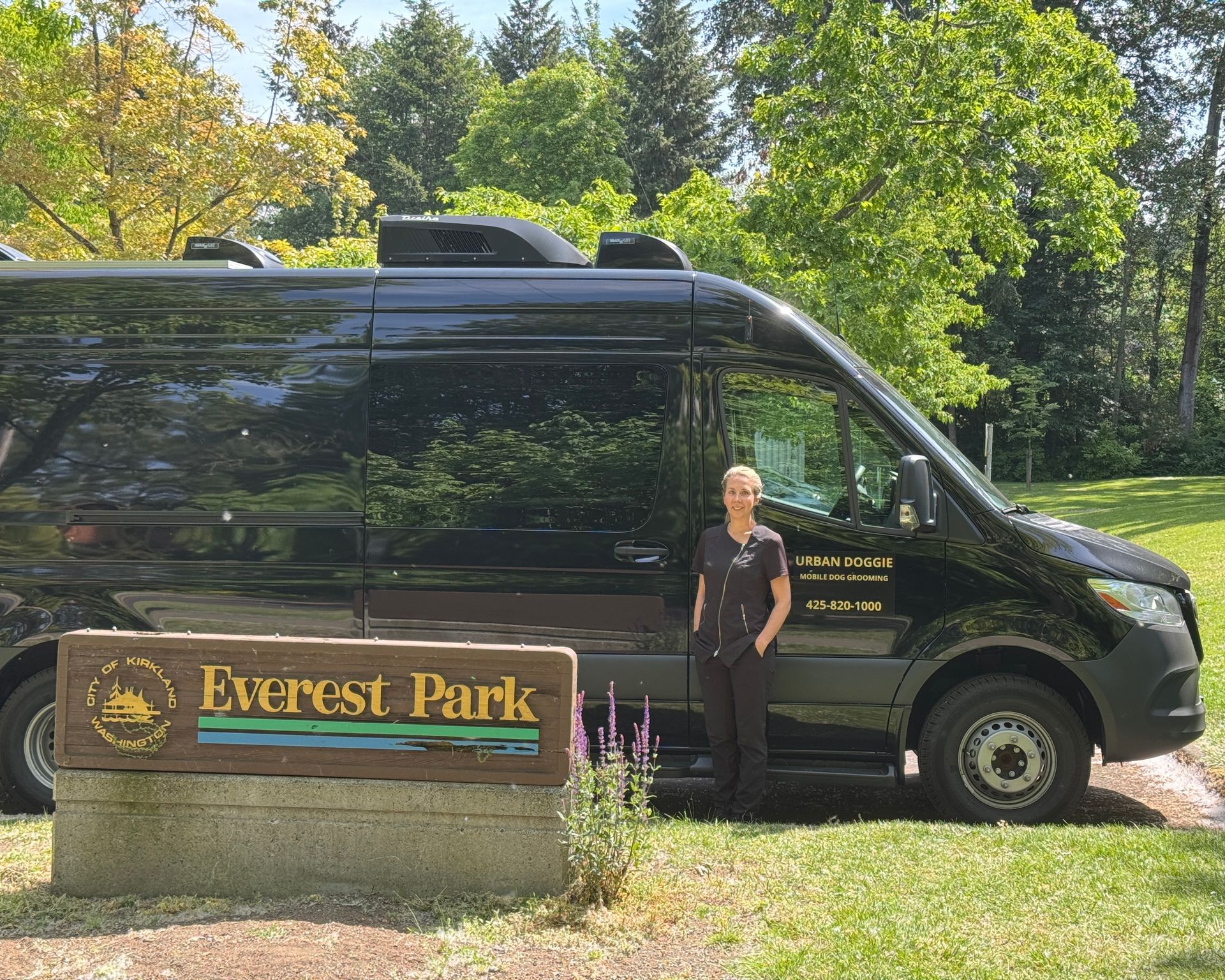 Urban Doggie Mobile Dog Grooming van and groomer Tia by the Everest neighborhood sign in Kirkland WA