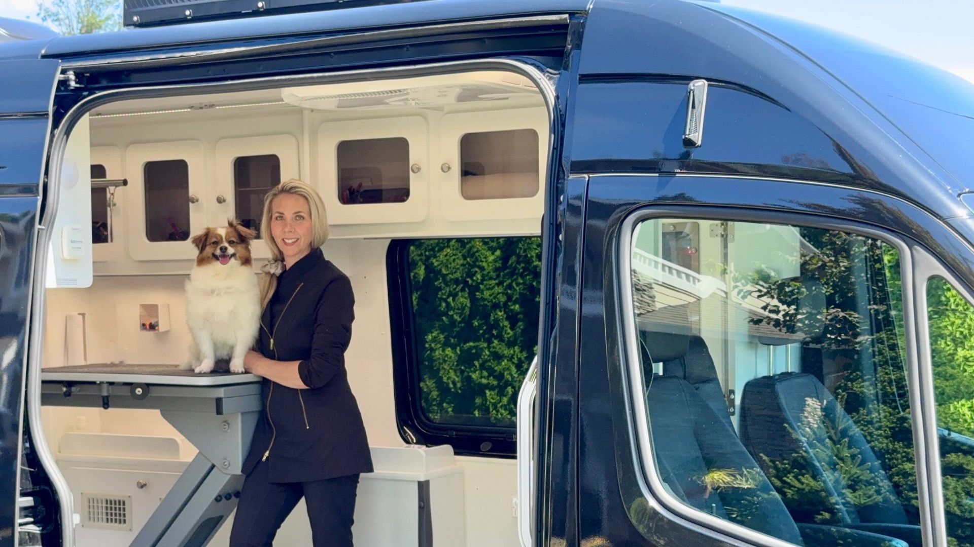 Owner and sole groomer of Urban Doggie Mobile Dog Grooming inside her grooming van