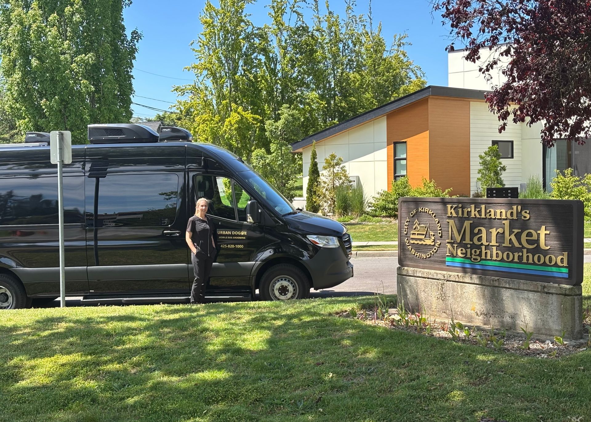 Urban Doggie Mobile Dog Grooming van and groomer Tia by the Market neighborhood sign in Kirkland WA