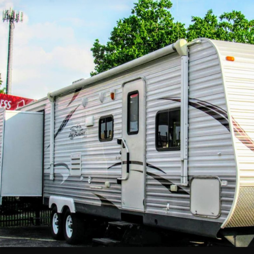 A white trailer is parked next to a red sign that says express