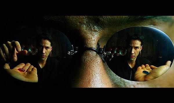 Morpheus reflected in sunglasses, offering a red pill in a dark scene from The Matrix.