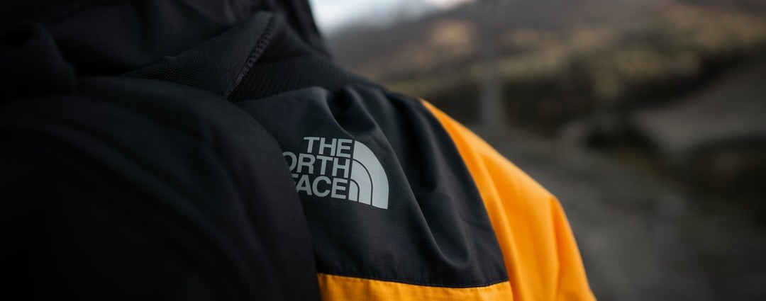 Um close de uma pessoa vestindo uma jaqueta North Face.