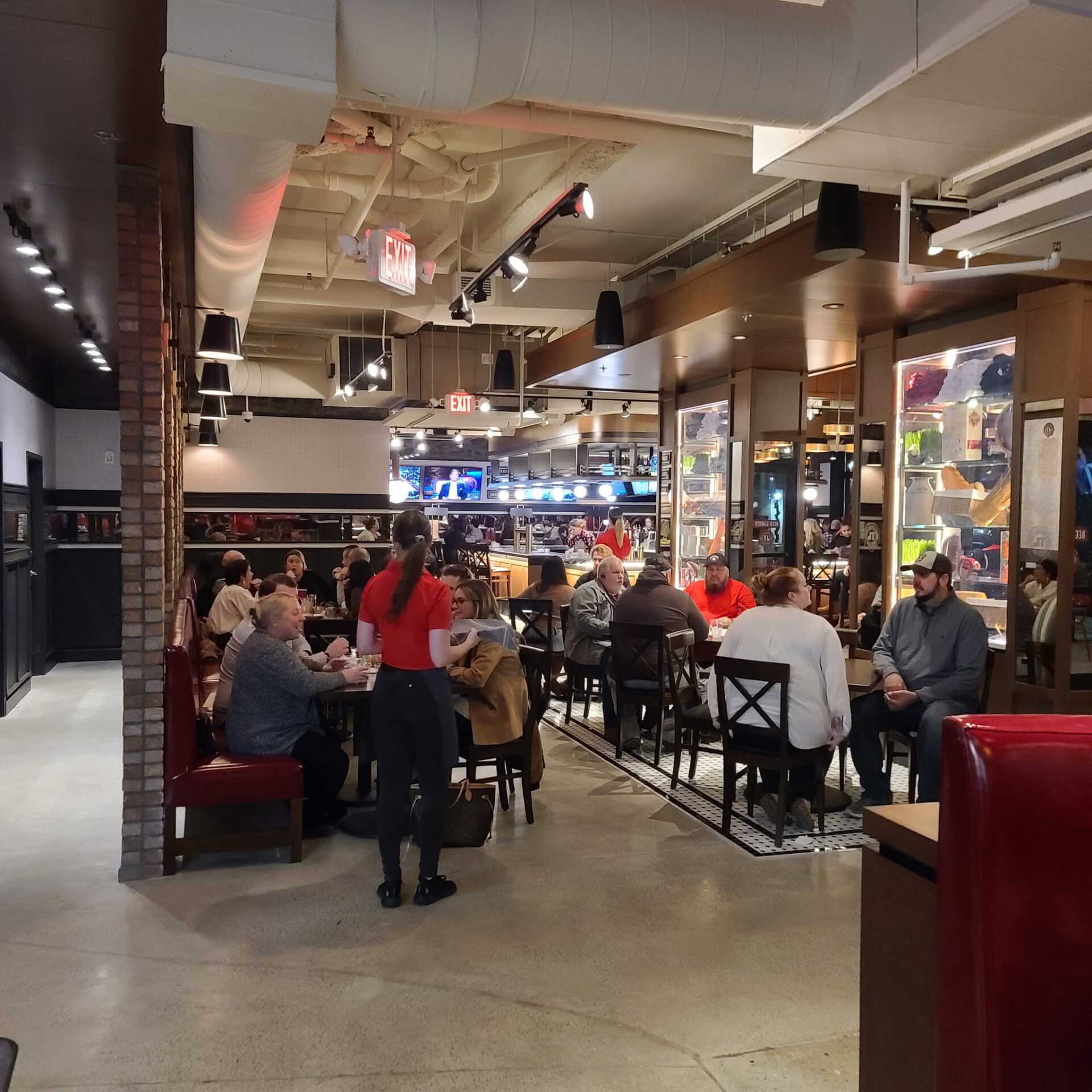 A group of people are sitting at tables in a restaurant