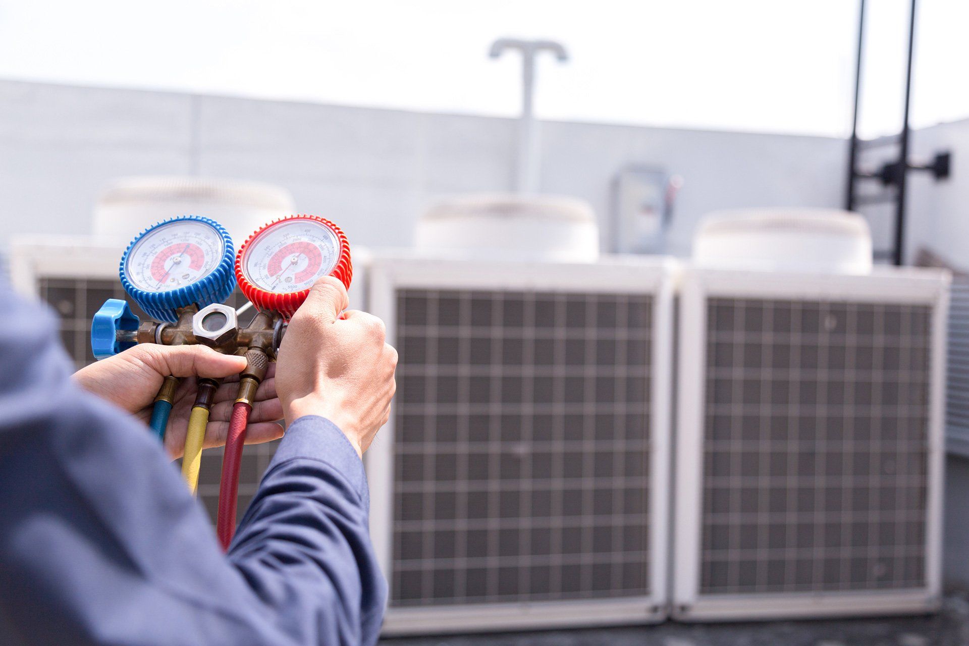 HVAC technician checking gauges