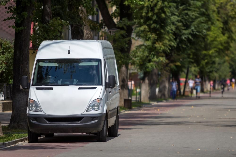 A White Van is Parked on the Side of the Road — Express City Couriers In Edmonton, QLD