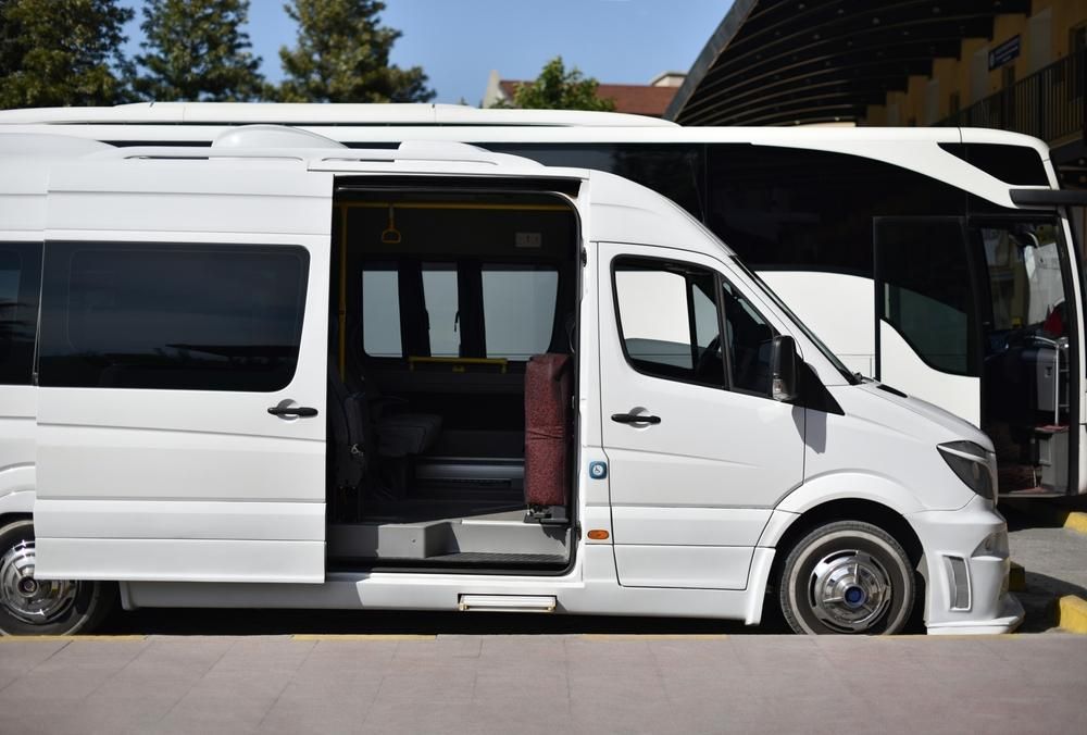 A White Van With Its Doors Open is Parked in Front of a Building — Express City Couriers In Edmonton, QLD