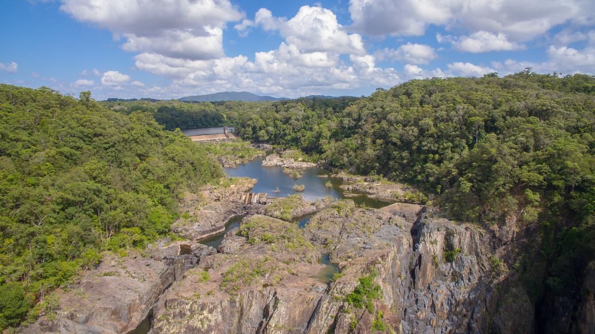 An Aerial View of a River Surrounded by Trees and Rocks — Express City Couriers In Edmonton, QLD