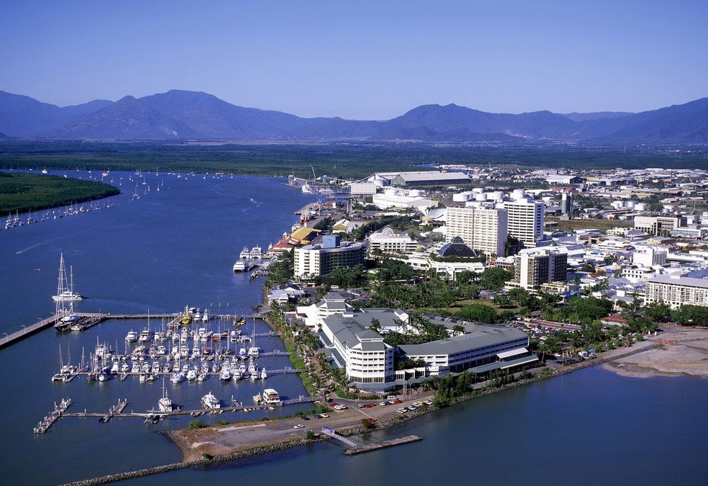 An Aerial View of a City Surrounded by Water and Mountains — Express City Couriers In Cairns, QLD