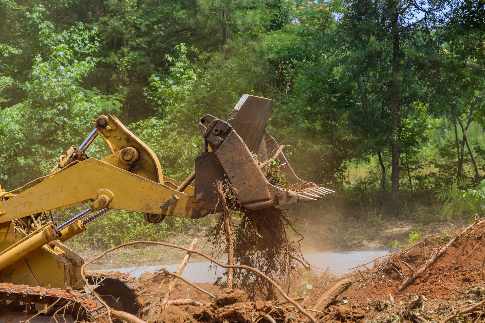 A bulldozer is moving dirt in a field.