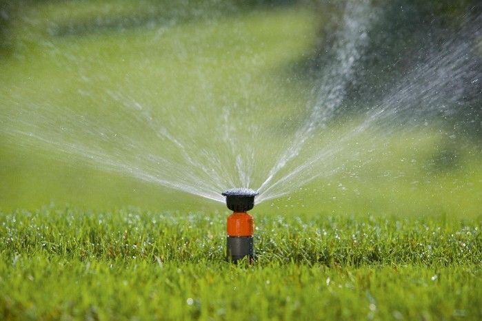 Sprinkler watering grass Sprinkler watering grass