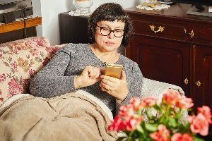A lady with her phone — New London, WI — Griebenow Eyecare Sc Clintonville A lady with her phone — New London, WI — Griebenow Eyecare Sc Clintonville
