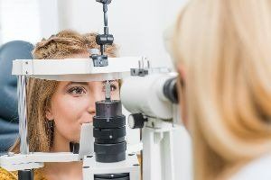 A young lady taking an eye test — New London, WI — Griebenow Eyecare Sc Clintonville A young lady taking an eye test — New London, WI — Griebenow Eyecare Sc Clintonville