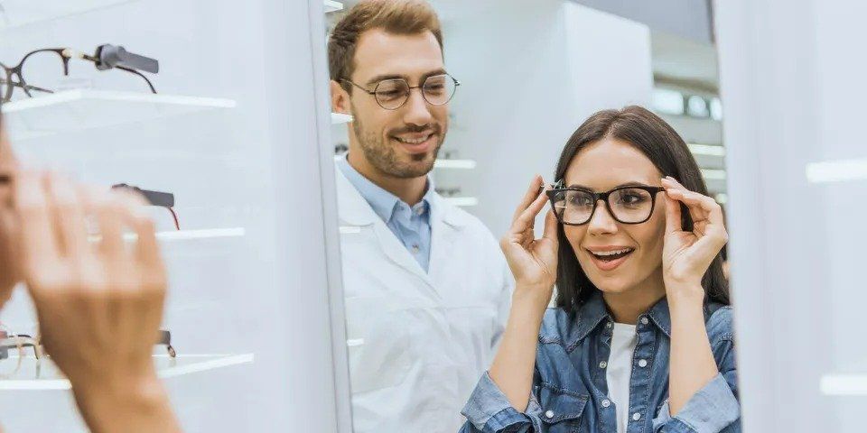 A lady with her eye doctor — New London, WI — Griebenow Eyecare Sc Clintonville