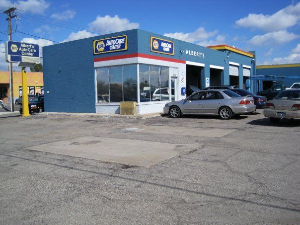 Several cars are parked in front of a napa auto care center