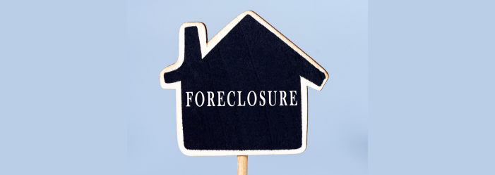 cardboard cutout of a home that is black and outlined white that says foreclosure