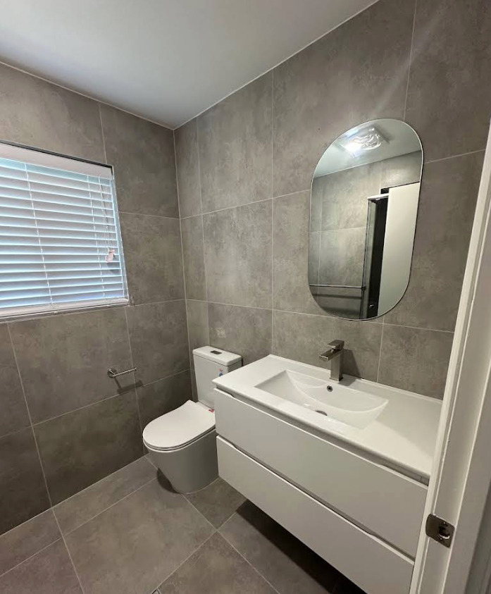 Toilet and Sink in Tiled Bathroom — Otto’s Plumbing & Gasfitting in Albany Creek, QLD