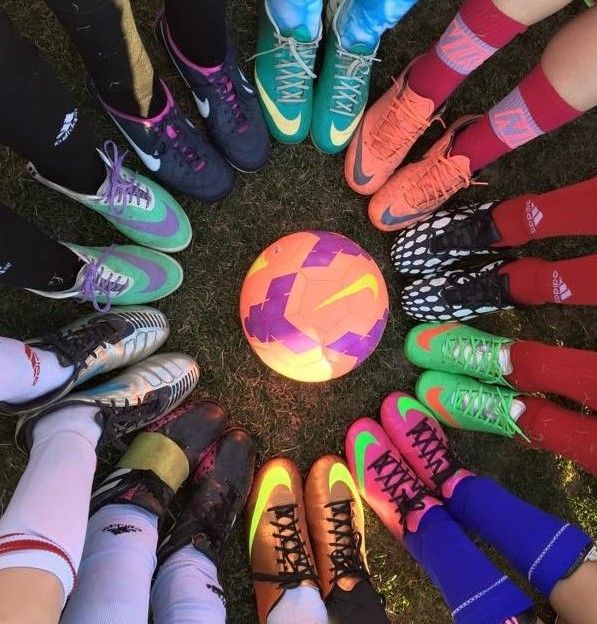 Soccer cleats in a circle around a ball