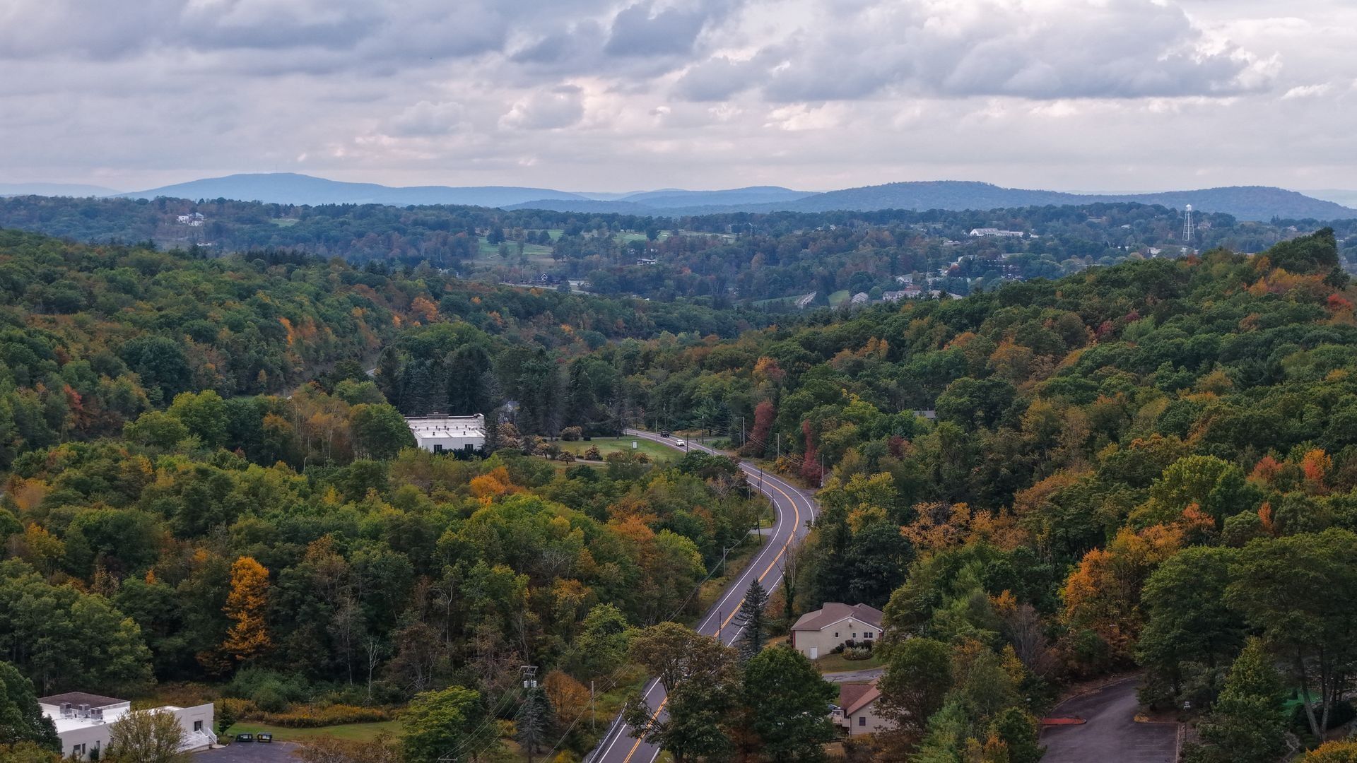 aerial view of clarks summit pa with green trees and mountains in the background