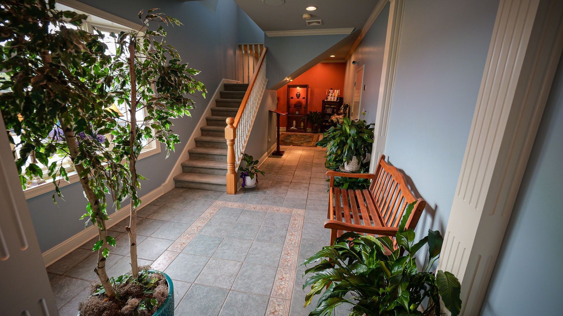 main entrance of aspen meadows pet memorial services with green plants and staircase