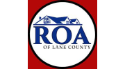ROA of Lane County logo: white circle with blue house outline, blue 