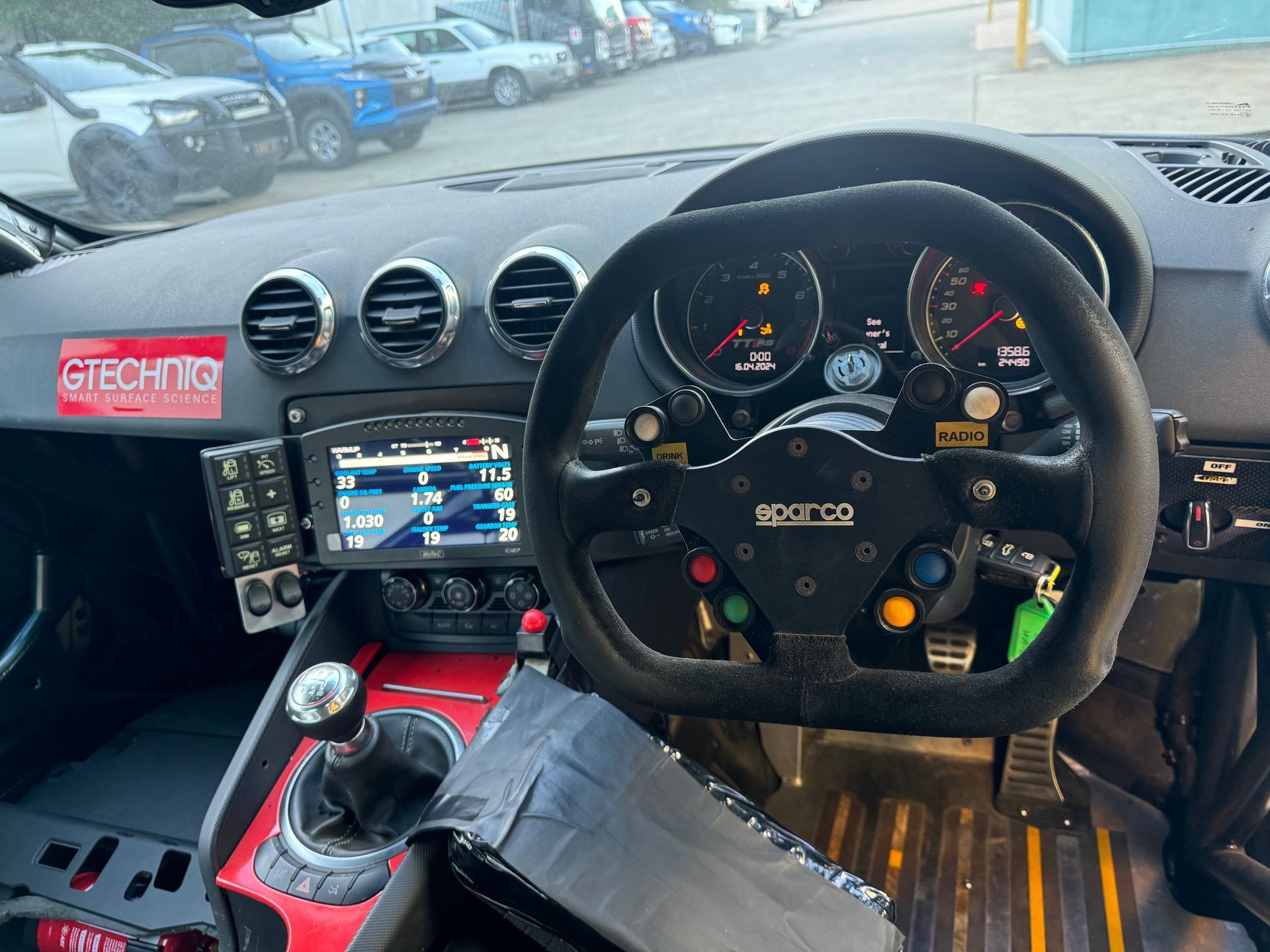 The inside of a car with a steering wheel and a sticker that says techno — HO Performance in Cleveland, QLD