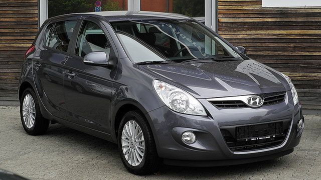 Gray Hyundai hatchback parked outdoors on a street, front three-quarter view
