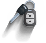 Car key and black key fob hanging from a key ring on a white background