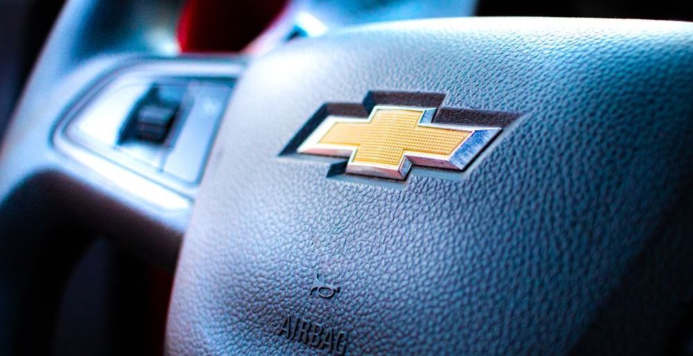 Close-up of a Chevrolet steering wheel with gold bowtie emblem and dashboard details