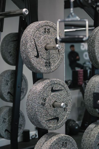A man is using a hoist machine in a gym