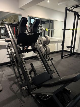 A gym with a lot of weights on the racks