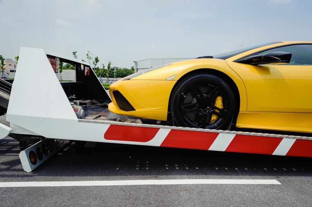 A Yellow Sports Car is Being Towed by a Tow Truck — Bulahdelah Towing In Coolongolook, NSW